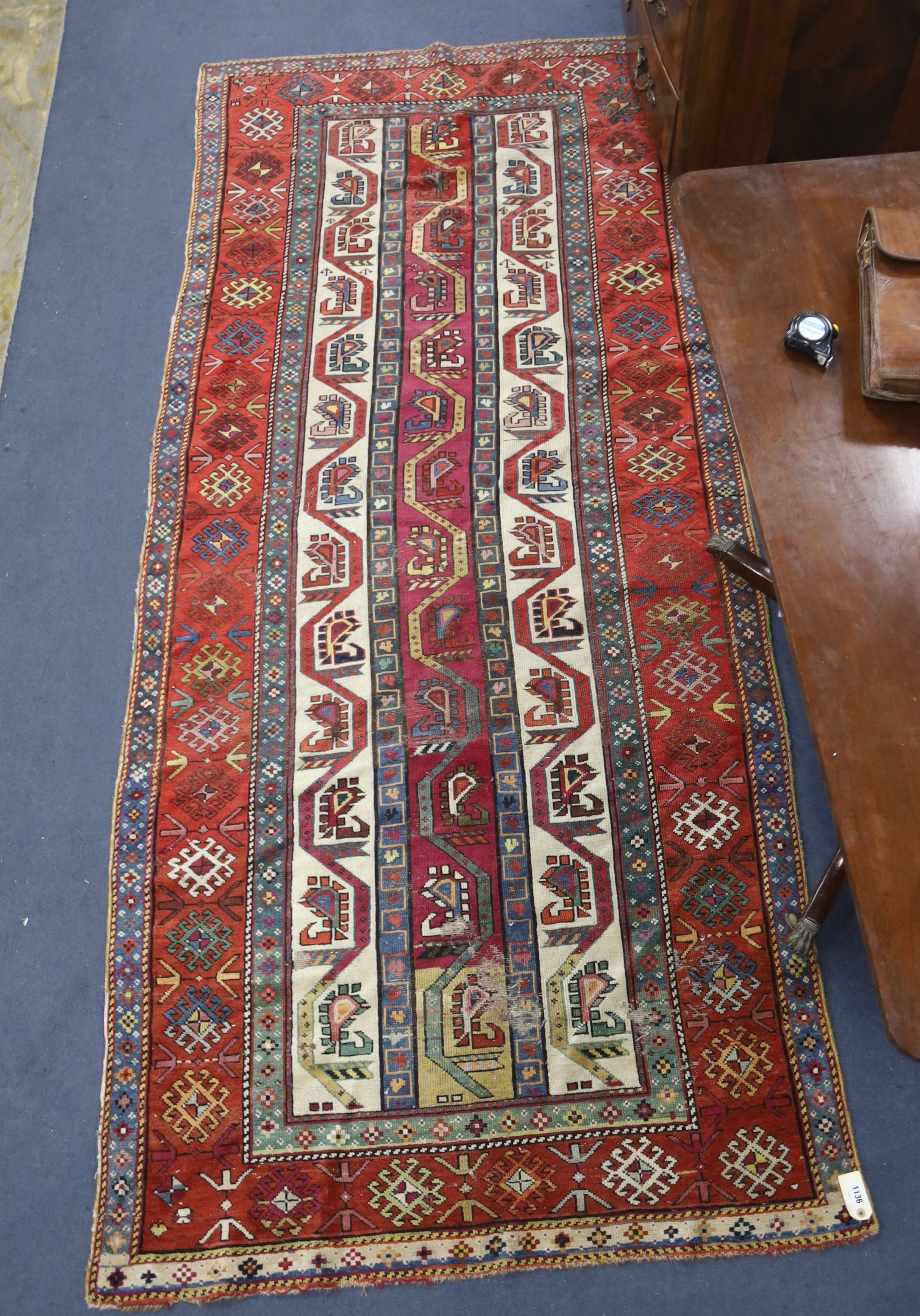 A Caucasian geometric rug, 284 x 118cm